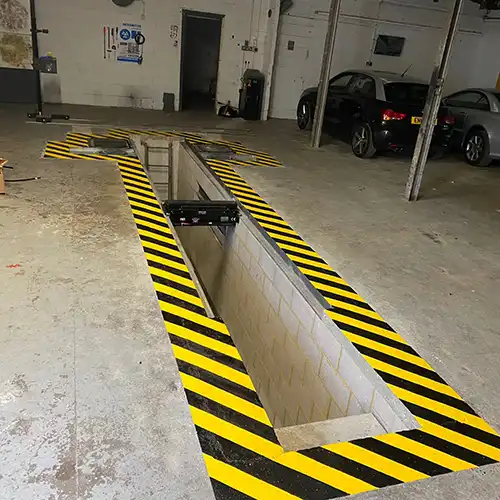a parking garage with yellow and black stripes