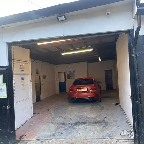 a red car is parked in a garage
